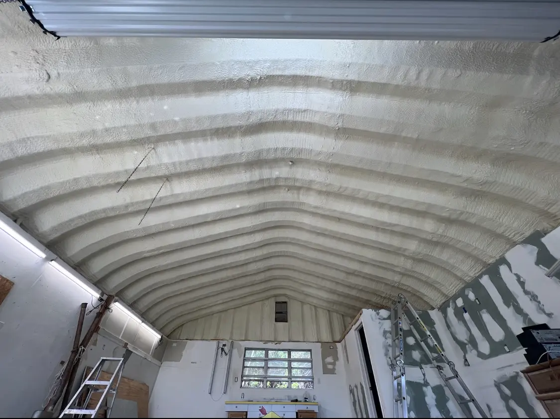 Spray polyurethane foam applied to the underside of a metal roof deck in Dennis